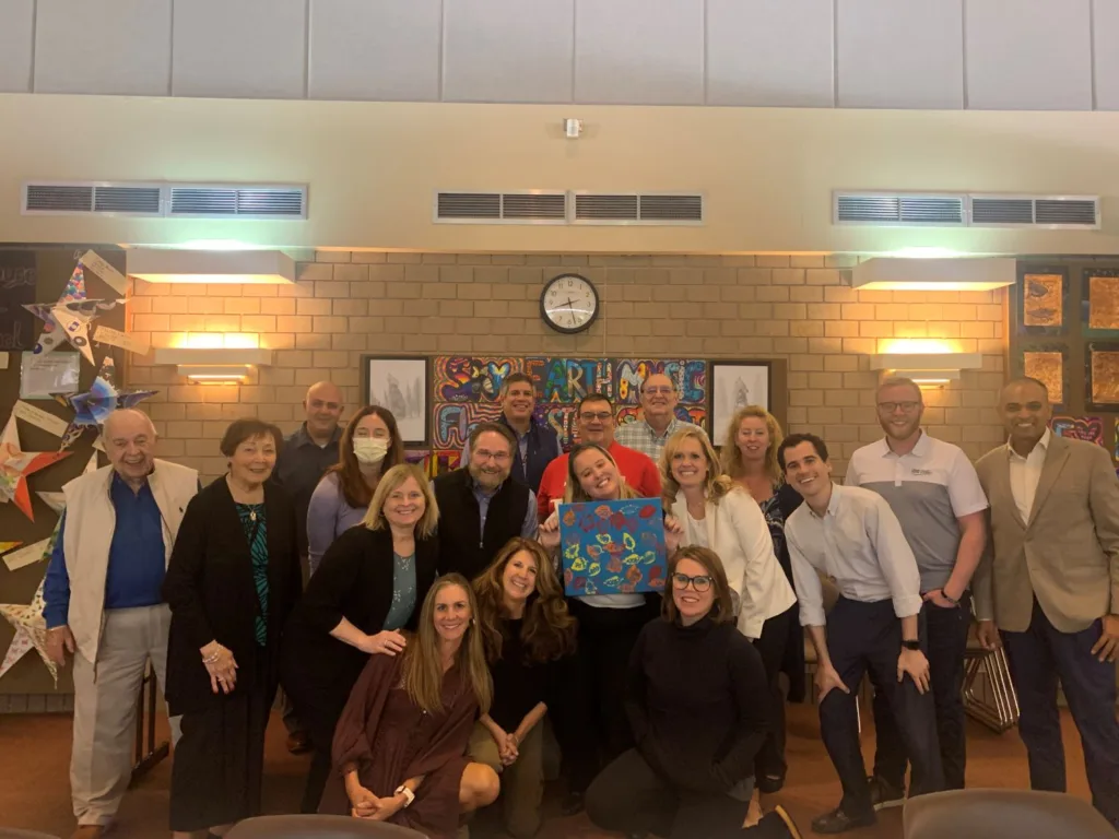 Parkland Education Foundation Board of Directors holding artwork made by special needs elementary art students