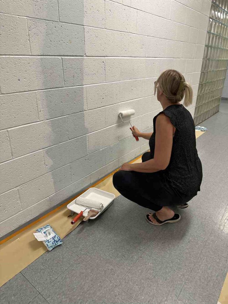 Women United Volunteer painting wall