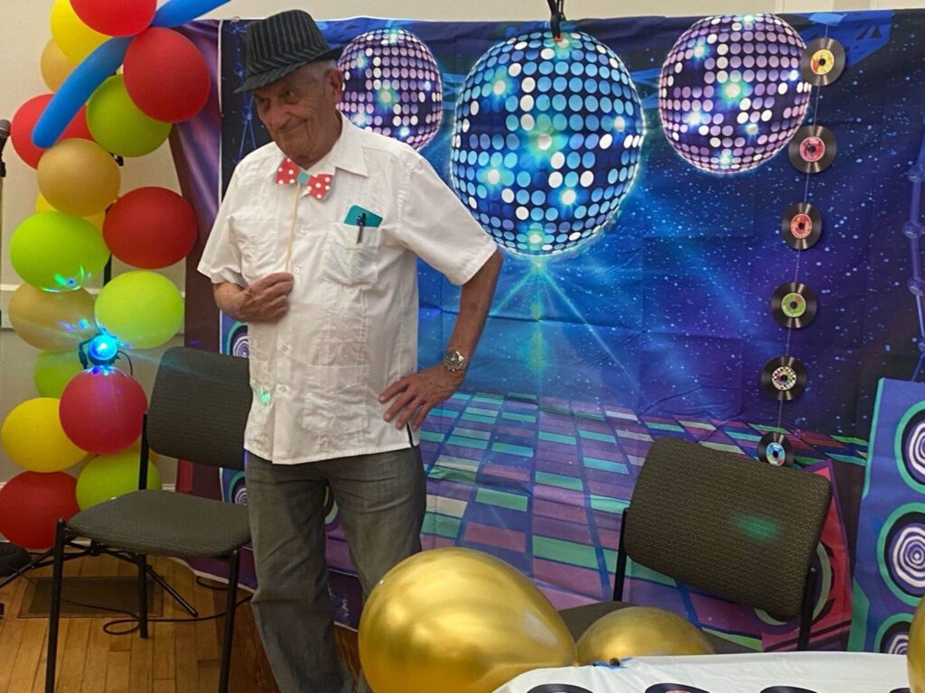 Male attendee posing at photo wall at the Motown Memories event at the Hispanic Center in Bethlehem