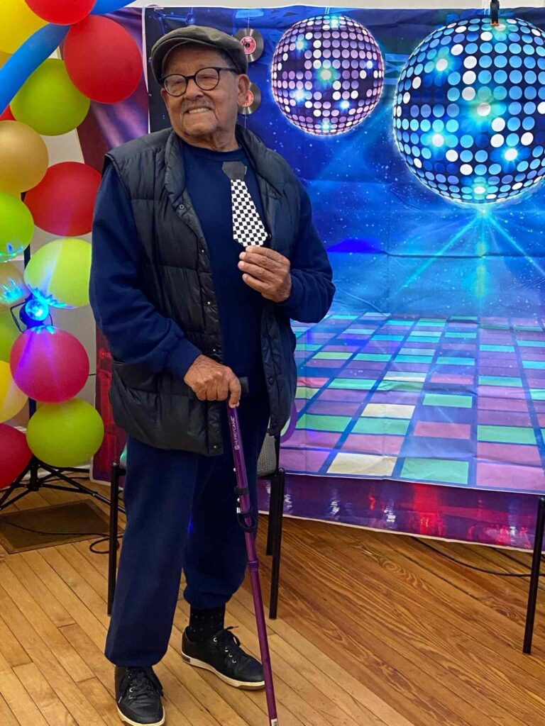 Male attendee posing in front of the photo wall at the Motown Memories event at the Hispanic Center in Bethlehem