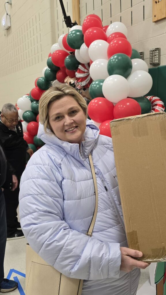 United Way's Marci Lesko unpacking presents at Roosevelt Elementary School in Allentown