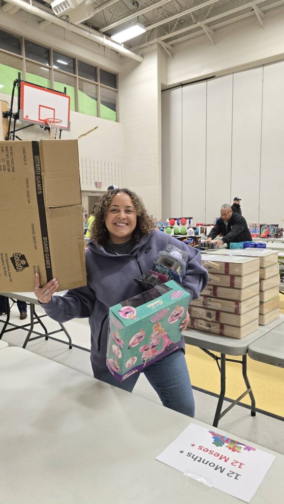 Volunteer at Roosevelt Elementary School in Allentown unpacking presents during the 2024 TeenWorks Toy Drive