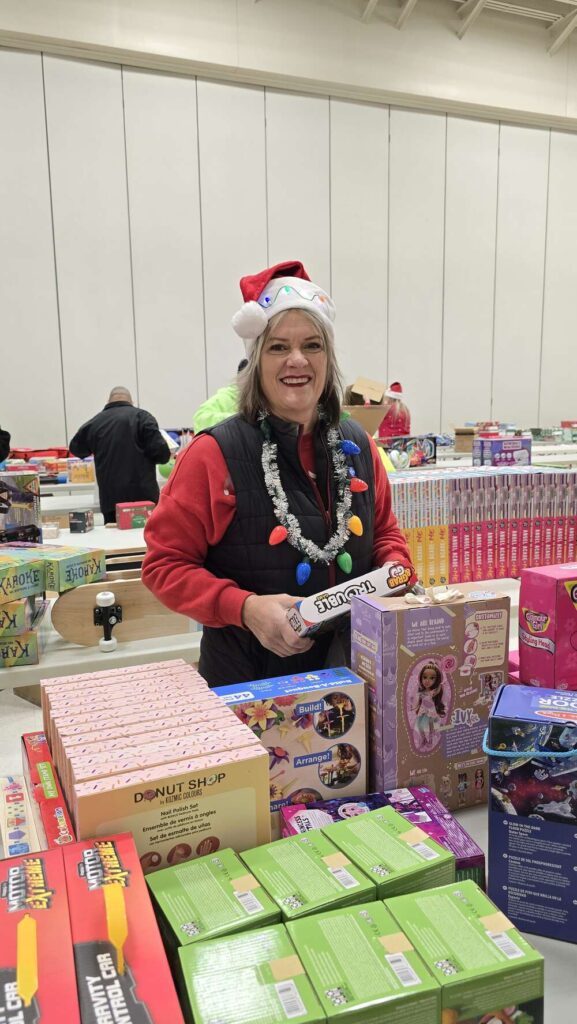 Volunteer at Roosevelt Elementary School in Allentown unpacking presents during the 2024 TeenWorks Toy Drive