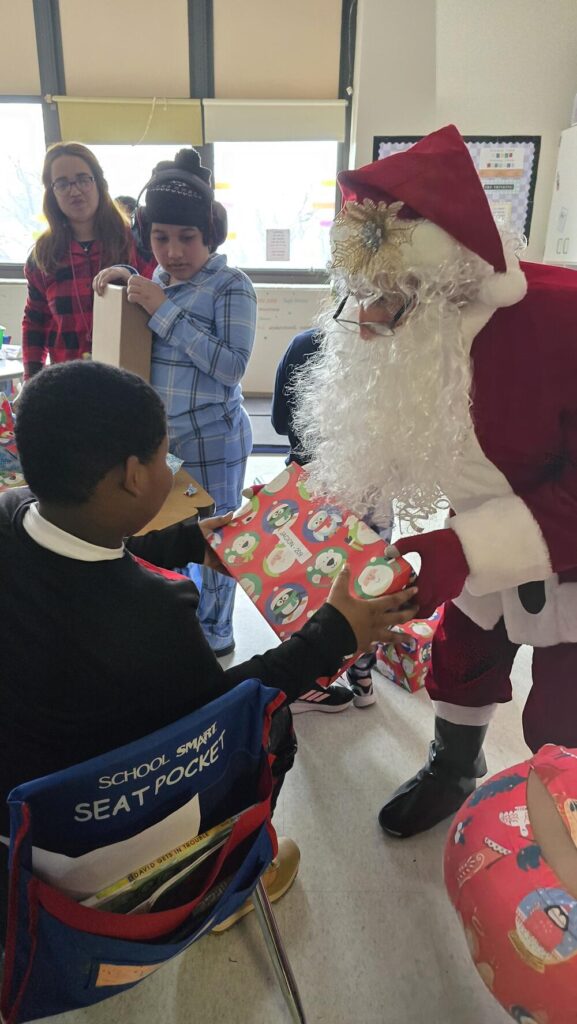 Santa with a child at Roosevelt Elementary School in Allentown