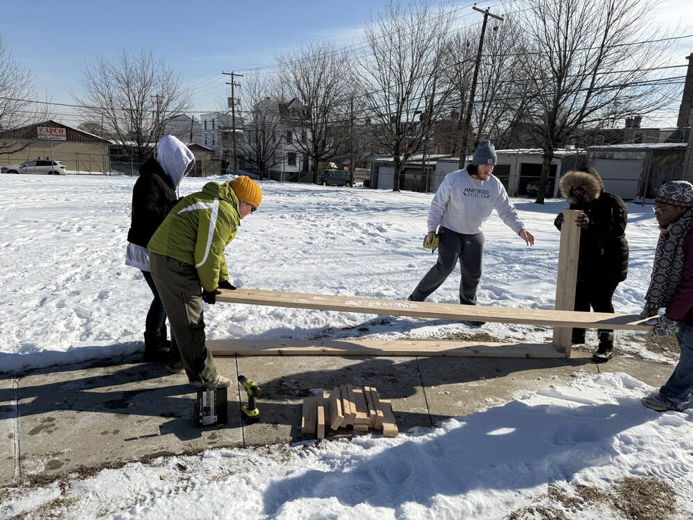 Americorp Vistas build garden beds at Ramos Elementary School for MLK Day