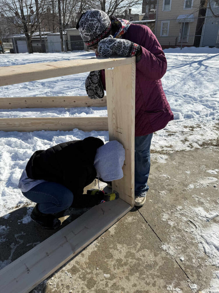 Americorp Vistas build garden beds at Ramos Elementary School for MLK Day