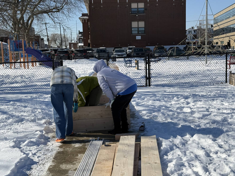 Americorp Vistas build garden beds at Ramos Elementary School for MLK Day