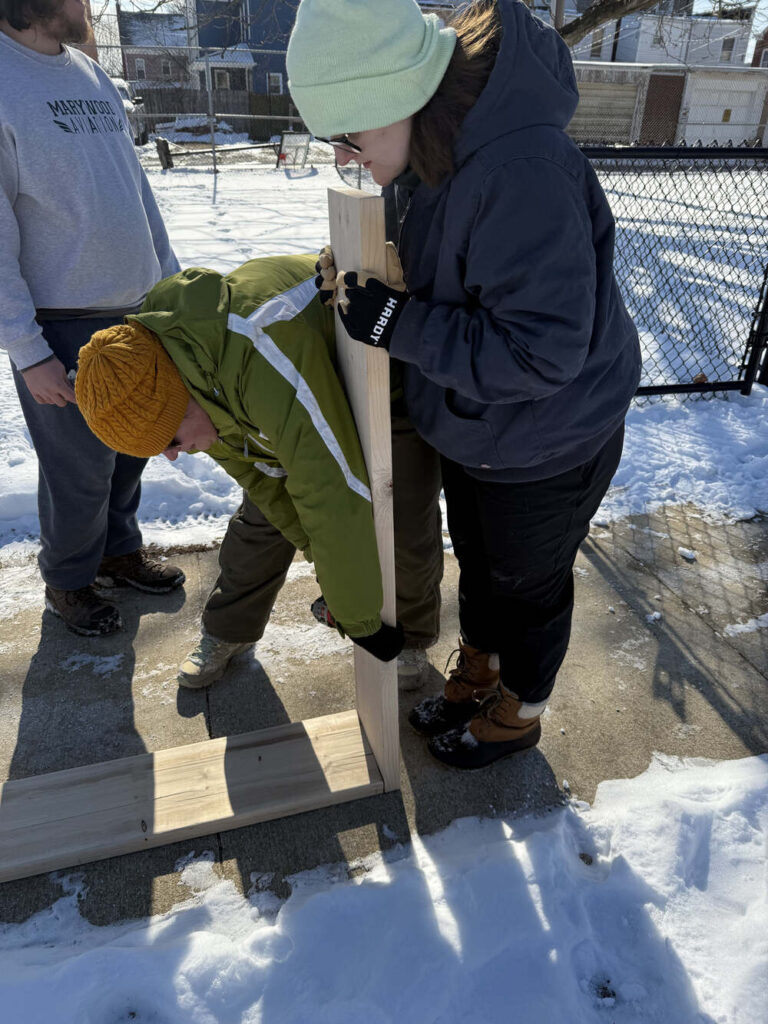 Americorp Vistas build garden beds at Ramos Elementary School for MLK Day