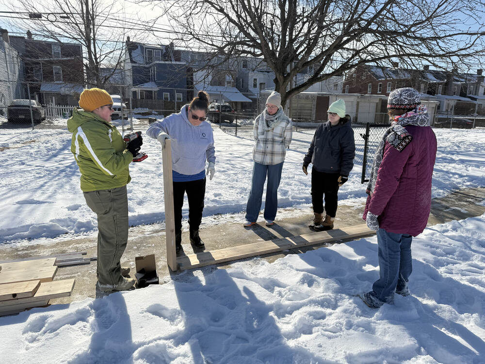 Americorp Vistas build garden beds at Ramos Elementary School for MLK Day