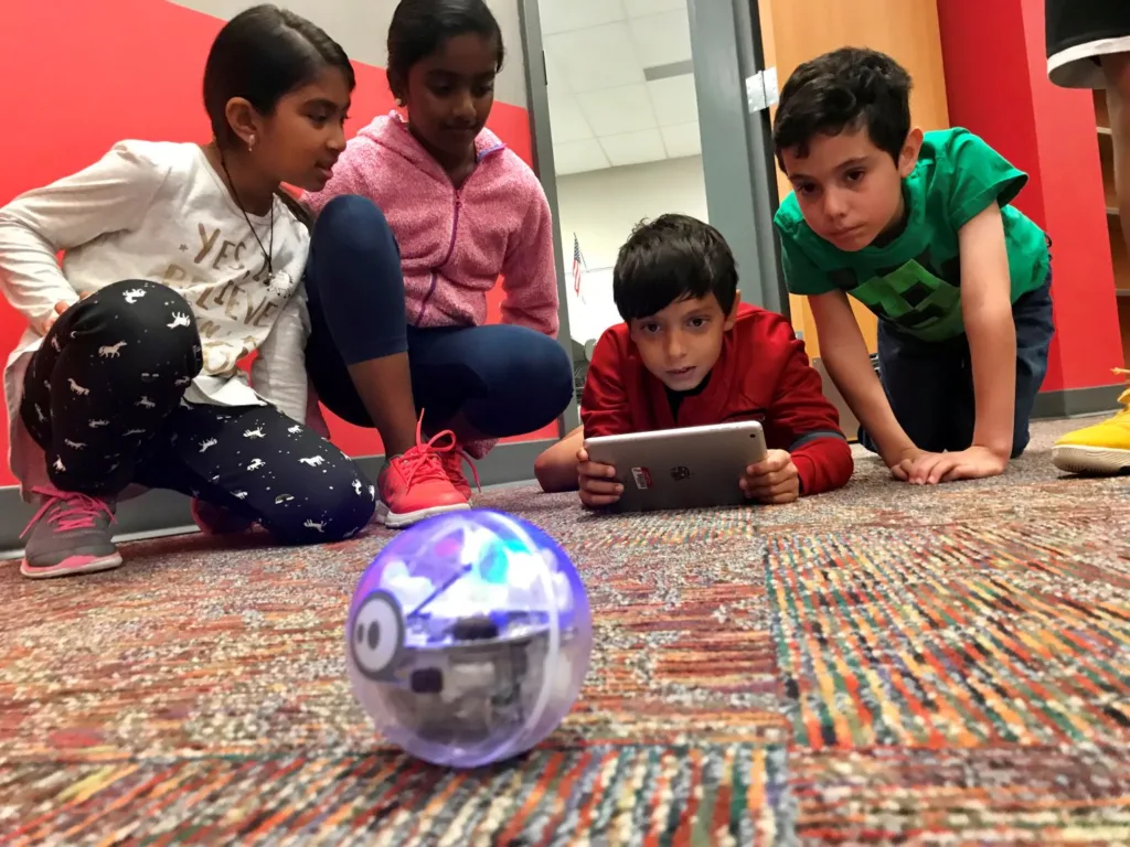 students using an ozobot in the Jaindl library makerspace to program and code