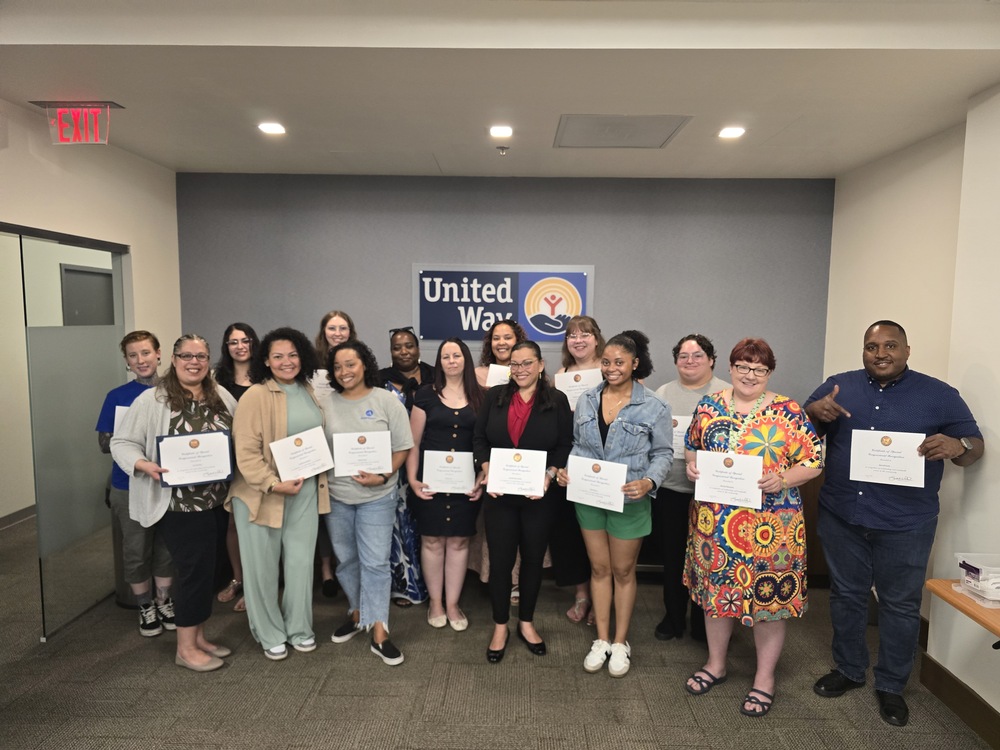 AmeriCorps members group shot holding up their certificates