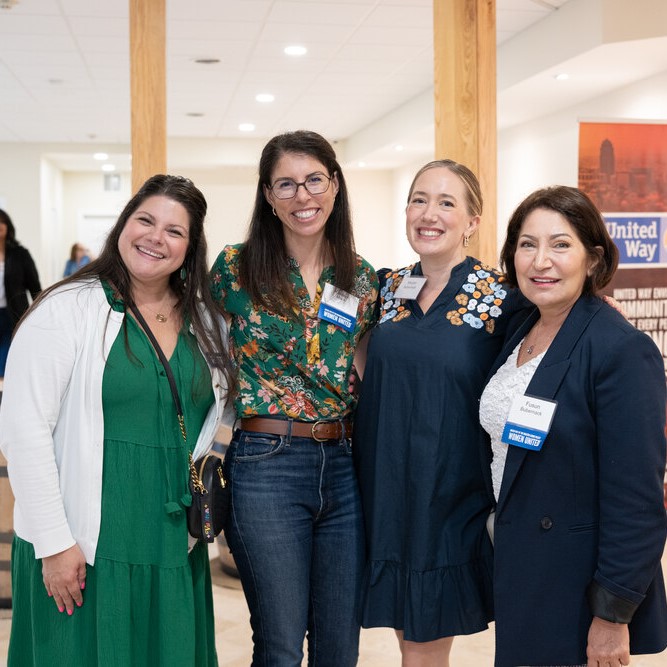 4 Women United event attendees pose for the camera - cropped