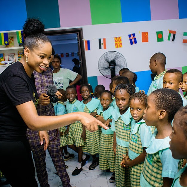 children gathered in front of a teacher