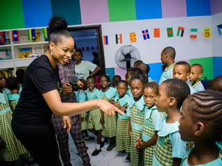 children gathered in front of a teacher