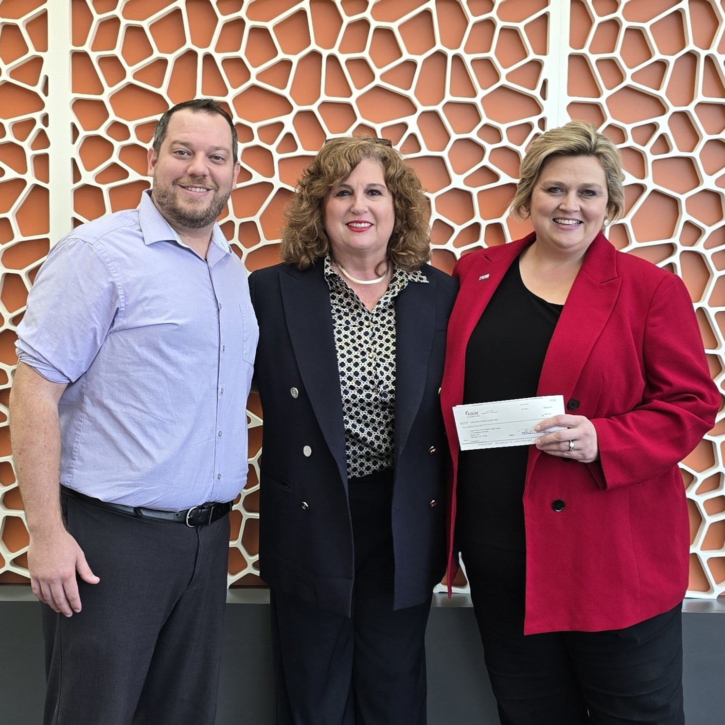 United Way's CEO Marci Lesko pictured with United Way's Shaun Marakovits and SpringHill Suites Nancy Derby with a check for support from SpringHill