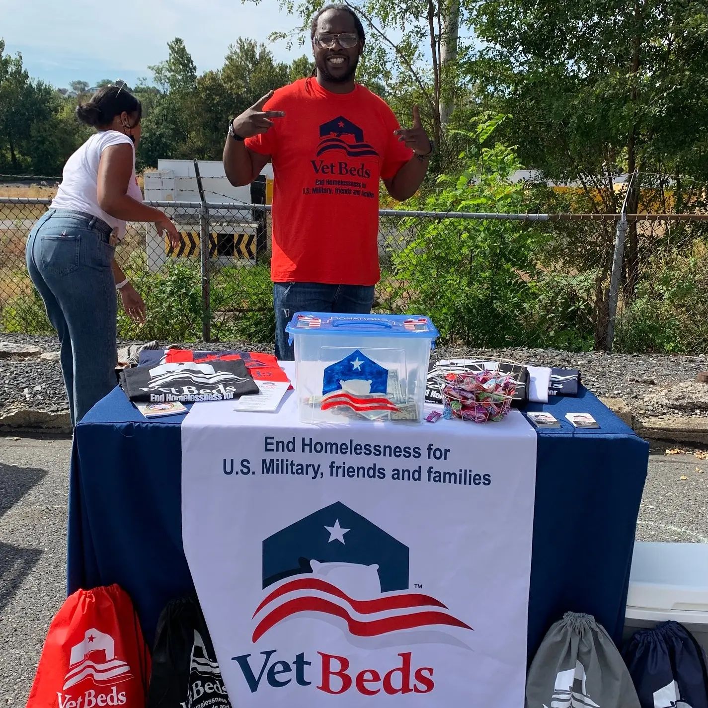 Vet Beds representative standing at his informational table at an event