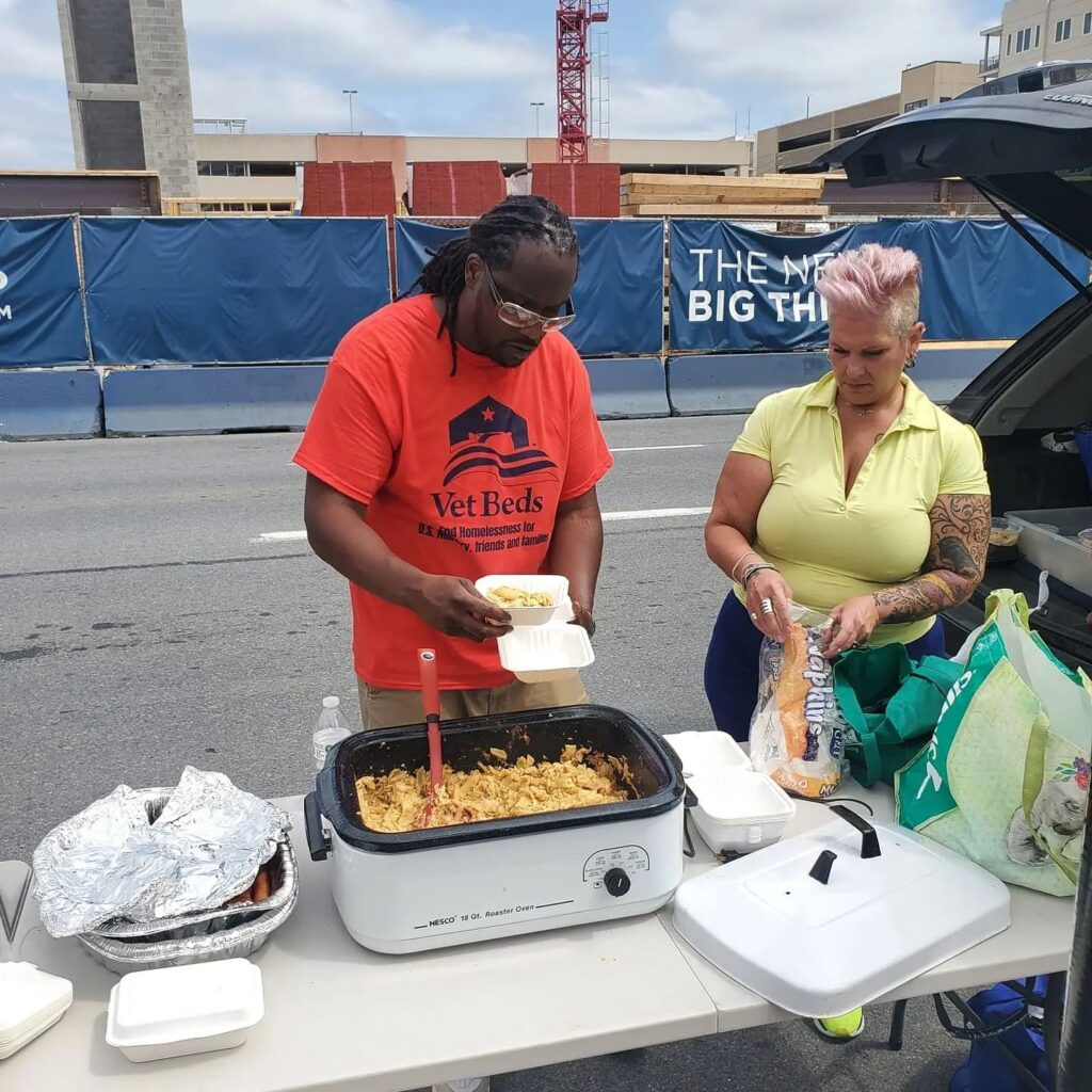 Vet Beds representative serving food at an event