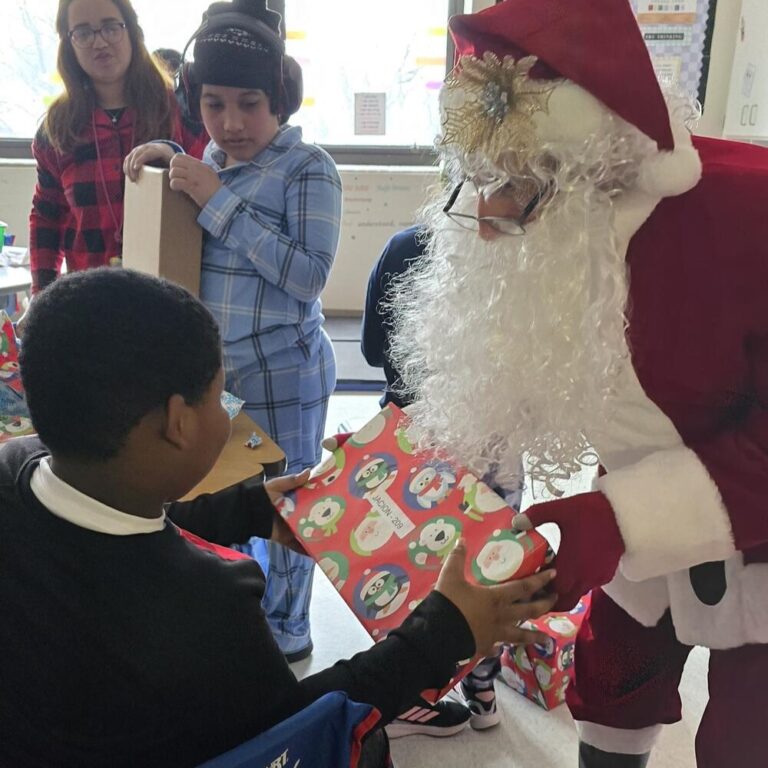 Santa with a child at Roosevelt Elementary School in Allentown