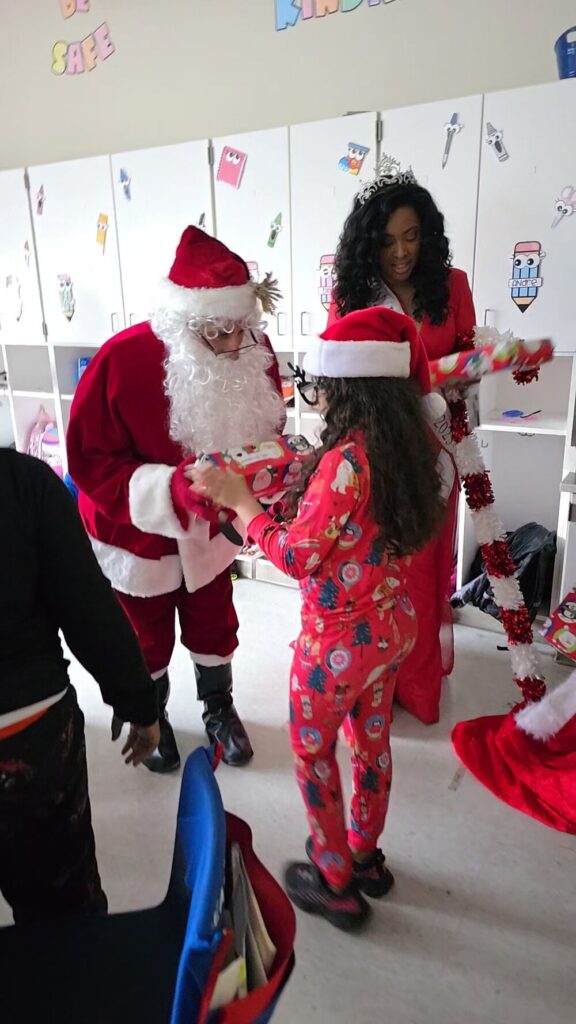 Santa with a child at Roosevelt Elementary School in Allentown