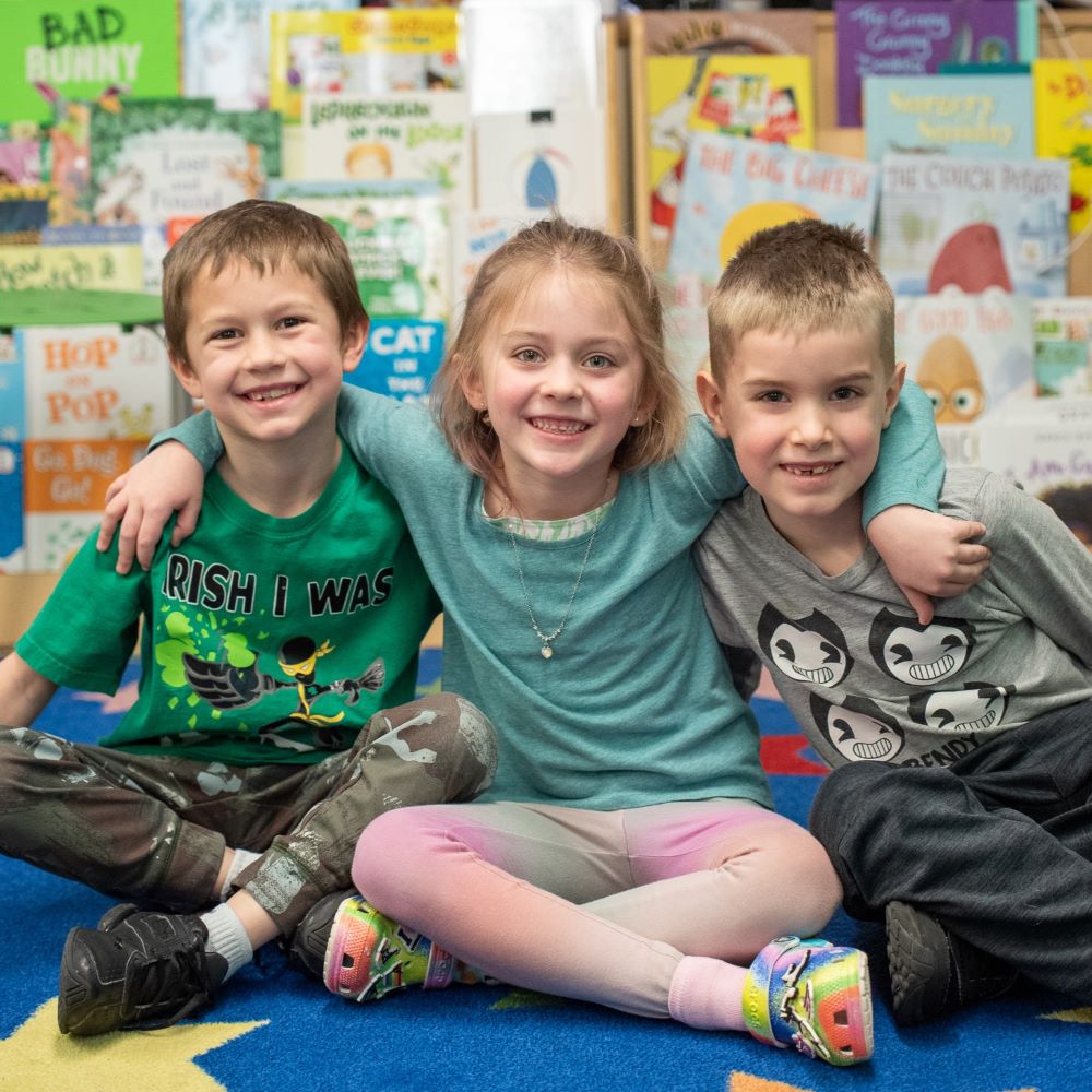 3 students at a United Way Community School smiling